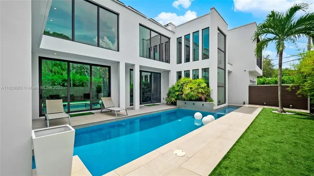 a living room with furniture a chandelier and a fireplace