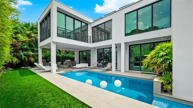 a living room with furniture fireplace and a large window