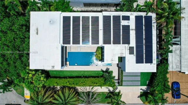 a car parked in front of a brick house with a large tree