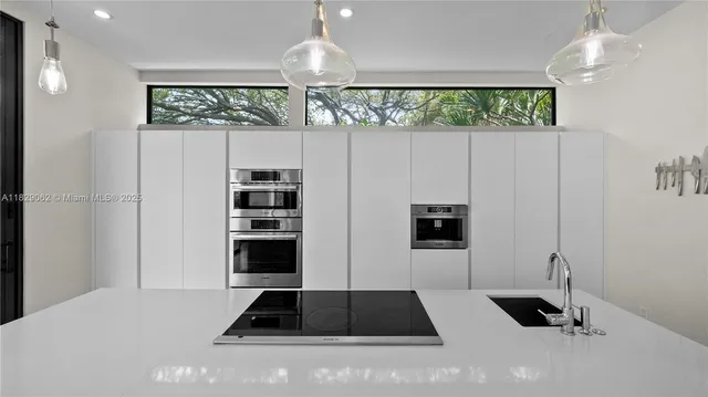 a living room with furniture and a ceiling fan