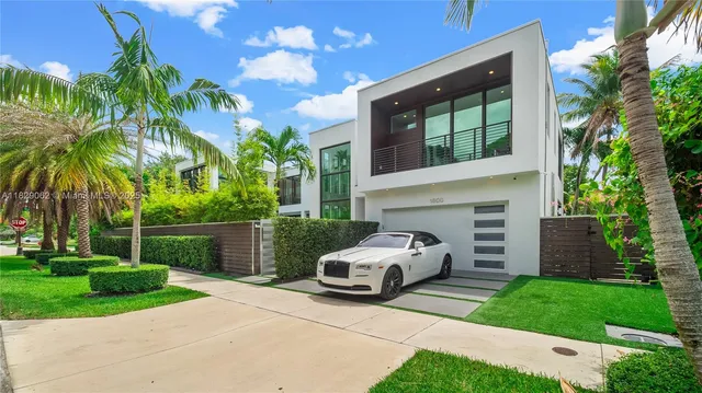 a view of a patio with table and chairs potted plants and palm tree