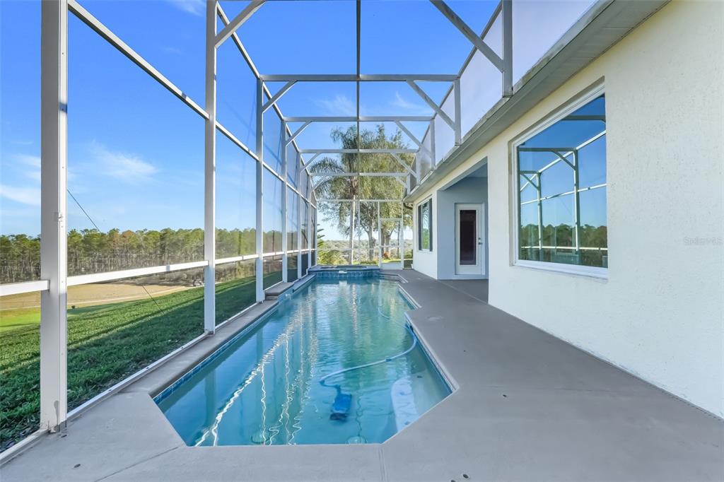 3862 Beacon Ridge Way Clermont, FL 34711 - Photo 2 of 56 a view of a swimming pool with a balcony