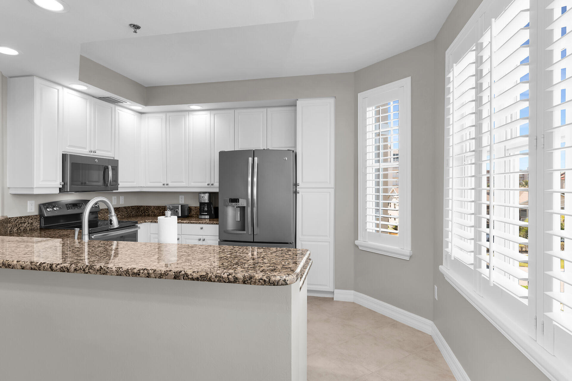 1111 Swallow Avenue, Unit 1401 Marco Island, FL 34145 - Photo 15 of 36 a kitchen with refrigerator and window