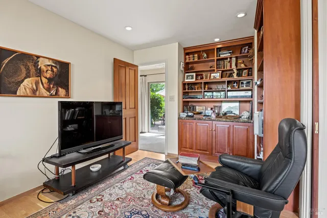 a living room with furniture a flat screen tv and a window