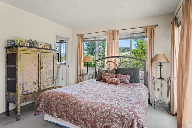 a bedroom with a large bed and a large window