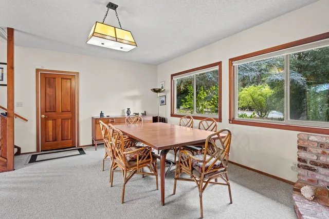 a dining room with furniture and a window