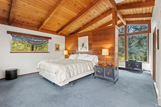 a spacious bedroom with a bed and a chandelier