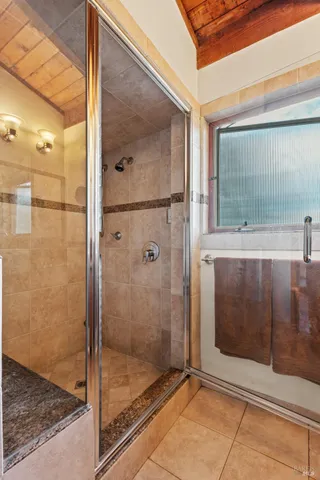 a bathroom with a glass shower door