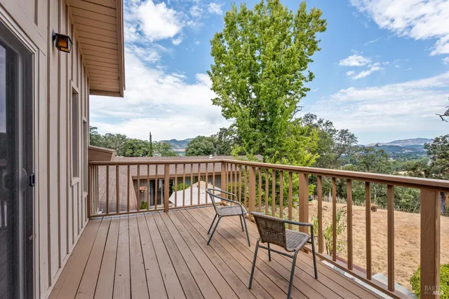 a view of balcony with wooden floor and fence
