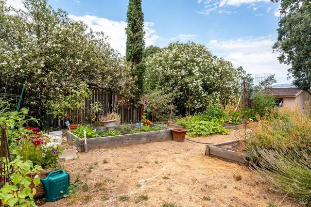 a view of a backyard with sitting area