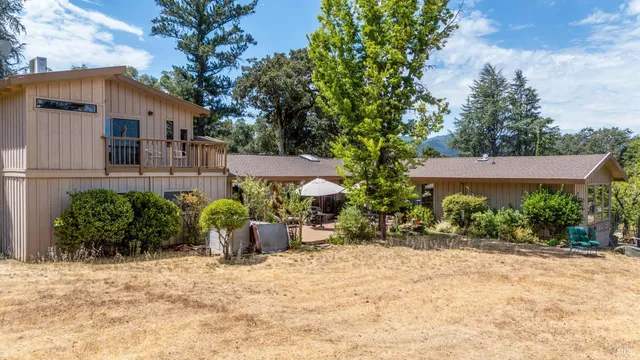 a view of a house with backyard and a garden