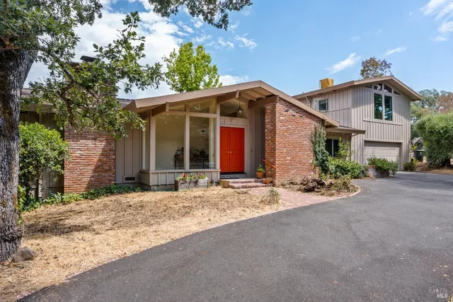a view of a house with a yard and garage