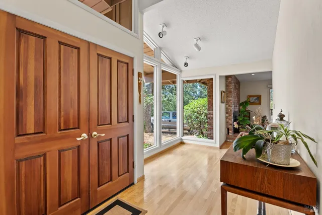 a hallway with furniture and wooden floor