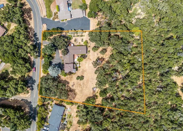 an aerial view of residential house with yard