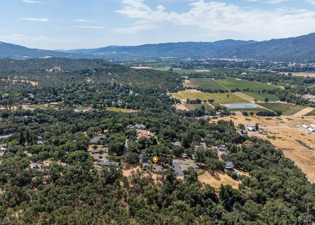 an aerial view of residential house and sandy dunes