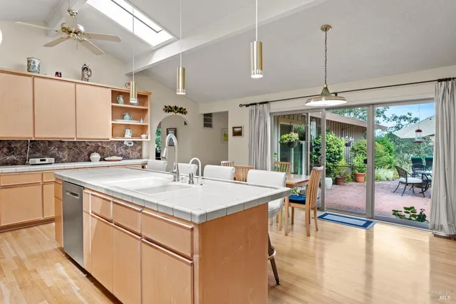 a kitchen with a table chairs stove and white cabinets