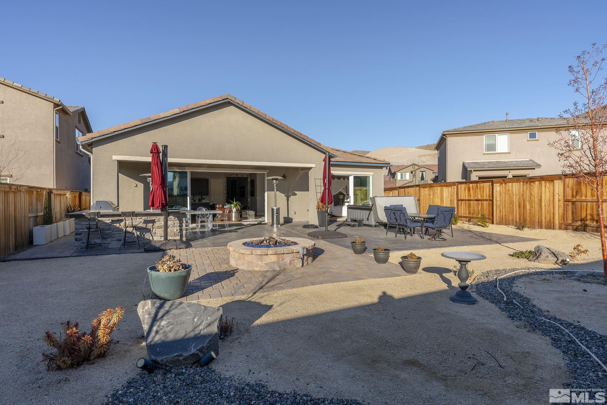 3010 Bonfire Lane Reno, NV 89521 - Photo 34 of 36 a view of a patio with dining table and chairs under an umbrellas