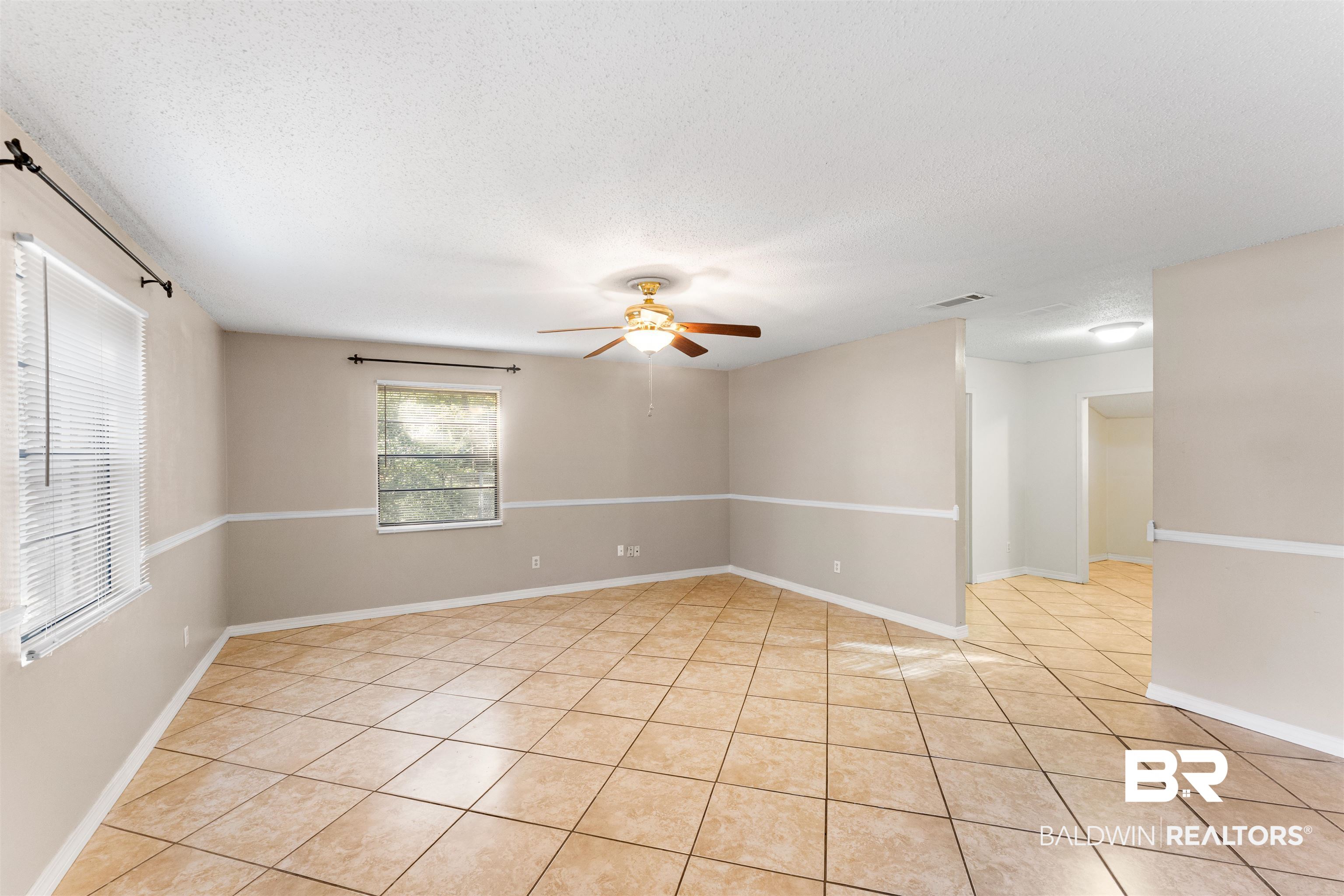 5551 Springer Court Theodore, AL 36582 - Photo 17 of 37 Empty room with ceiling fan, a textured ceiling, and light tile patterned flooring