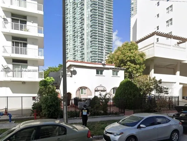 a view of cars parked in front of a building