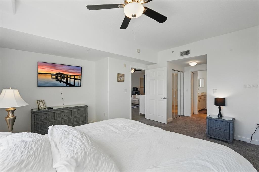 80 Surfview Drive, Unit 511 Palm Coast, FL 32137 - Photo 11 of 25 a bedroom with a bed and a chandelier