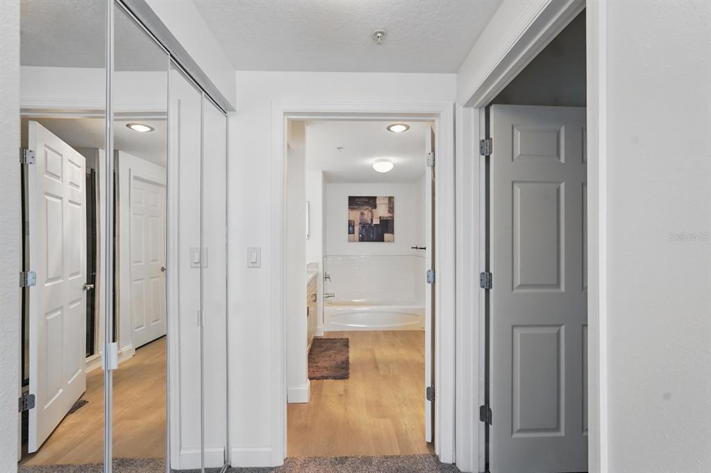 80 Surfview Drive, Unit 511 Palm Coast, FL 32137 - Photo 12 of 25 a bathroom with a glass shower door and a mirror