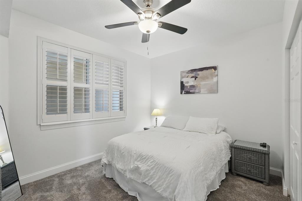 80 Surfview Drive, Unit 511 Palm Coast, FL 32137 - Photo 13 of 25 a bedroom with a large bed and a window