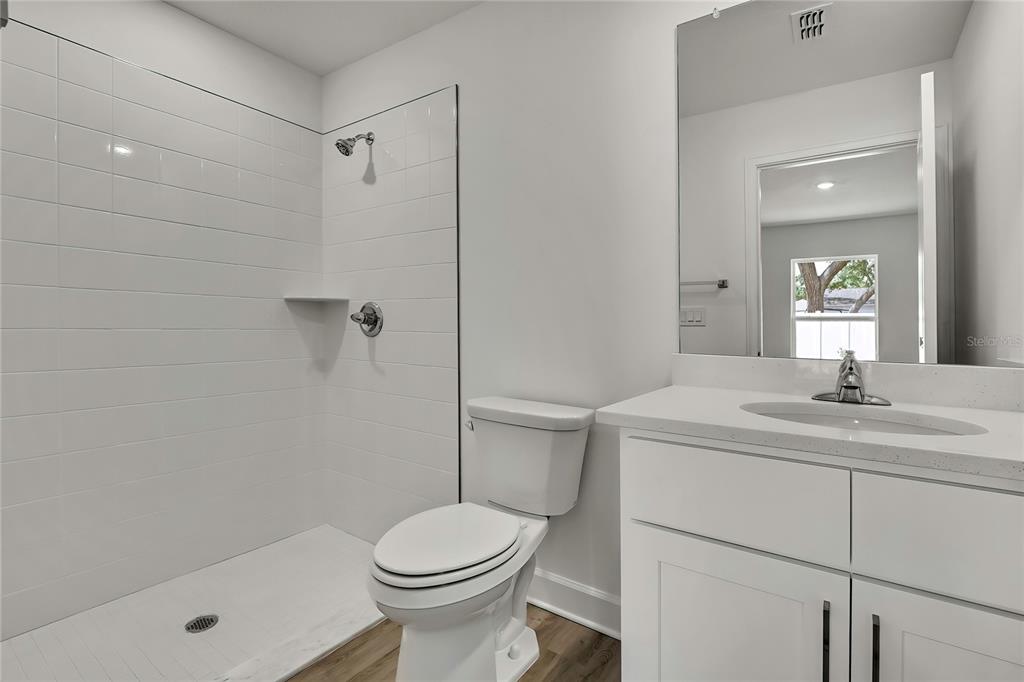 3646 Portillo Road Spring Hill, FL 34608 - Photo 8 of 16 a bathroom with a sink a toilet and shower