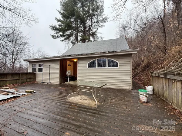 a backyard of a house with fire pit and trees