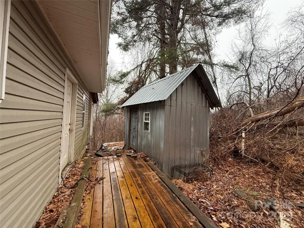 a view of wooden house with a wooden fence and floor