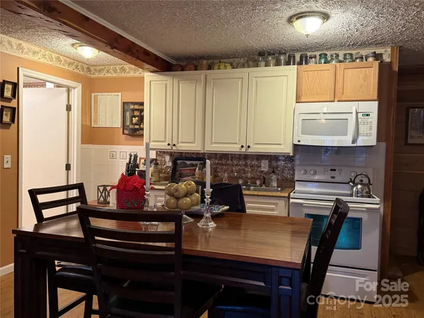 a view of a dining room with furniture and a window