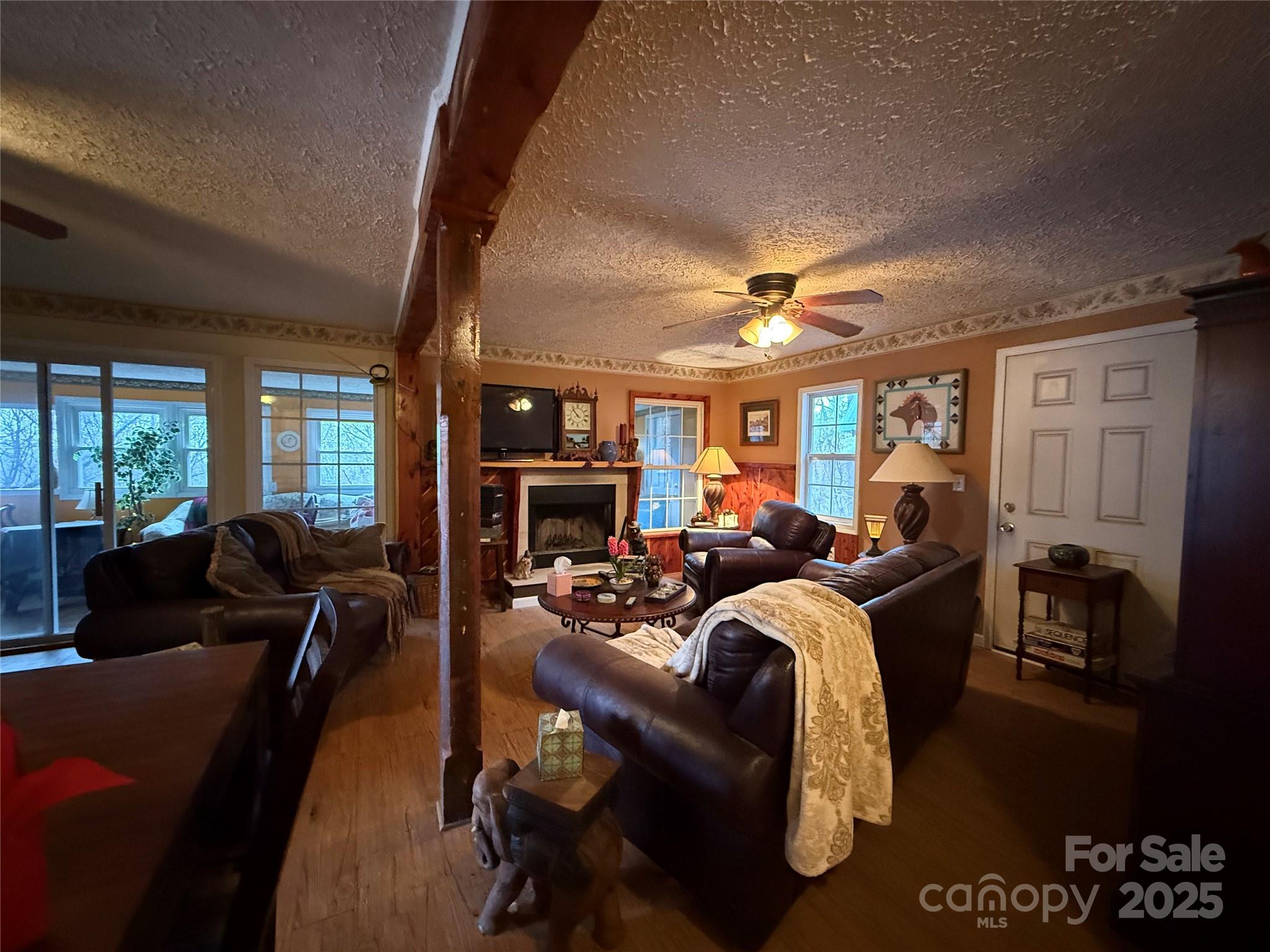 201 Mountain Vista Road Canton, NC 28716 - Photo 8 of 21 a living room with furniture a fireplace and a large window