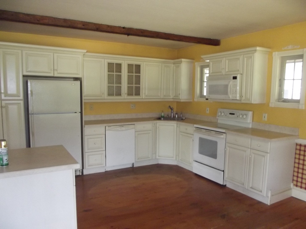 123 Willard Road Ashburnham, MA 01430 - Photo 11 of 15 a kitchen with granite countertop white cabinets and white appliances