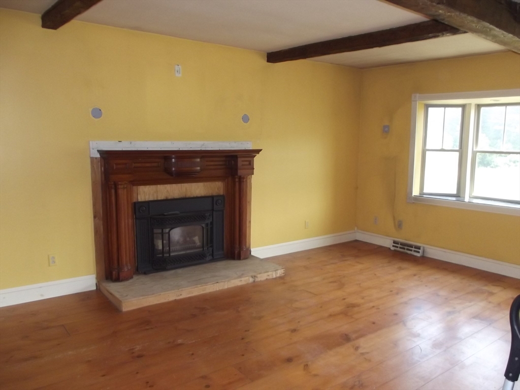 123 Willard Road Ashburnham, MA 01430 - Photo 9 of 15 an empty room with a fireplace and window