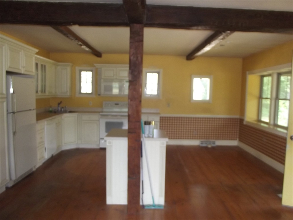 123 Willard Road Ashburnham, MA 01430 - Photo 10 of 15 a view of a hallway with wooden floor and a living room
