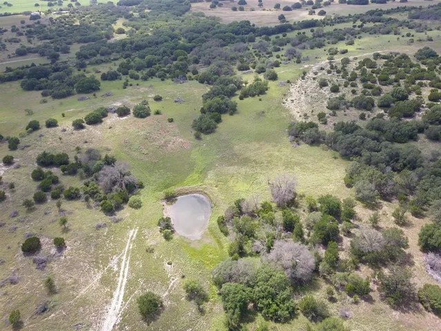 a aerial view of a houses with a yard