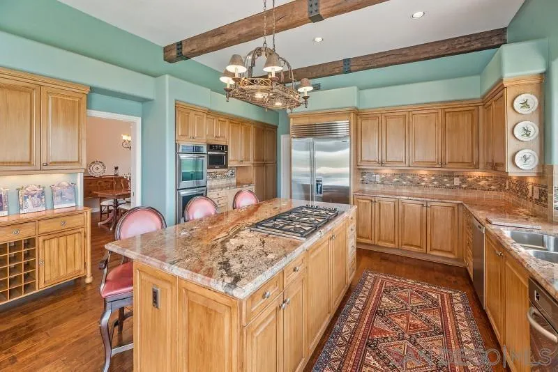 14370 Harvest Crescent Poway, CA 92064 - Photo 21 of 56 a kitchen with stainless steel appliances granite countertop a stove a sink dishwasher and cabinets with wooden floor