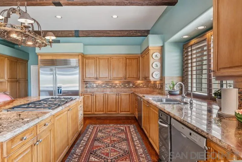 14370 Harvest Crescent Poway, CA 92064 - Photo 22 of 56 a kitchen with stainless steel appliances granite countertop a sink stove and cabinets