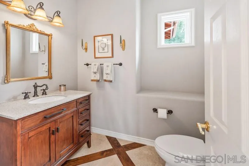 14370 Harvest Crescent Poway, CA 92064 - Photo 29 of 56 a bathroom with a sink a toilet and mirror