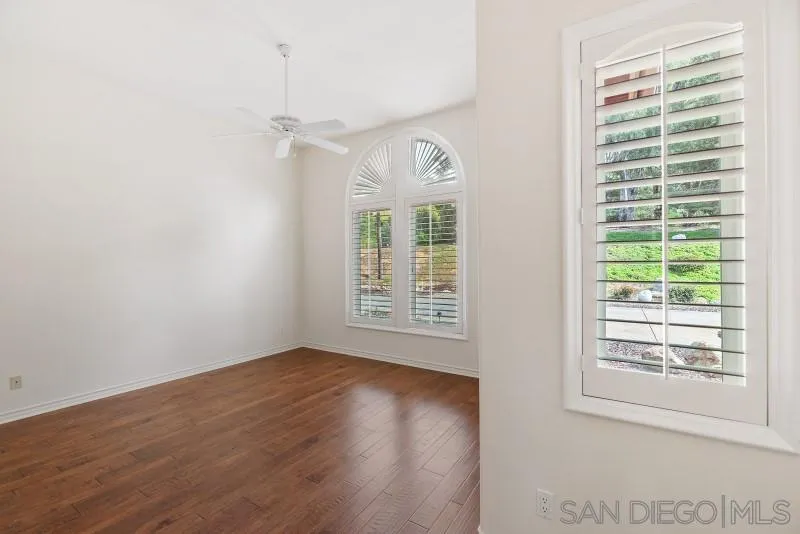 14370 Harvest Crescent Poway, CA 92064 - Photo 42 of 56 a view of an empty room with wooden floor and a window