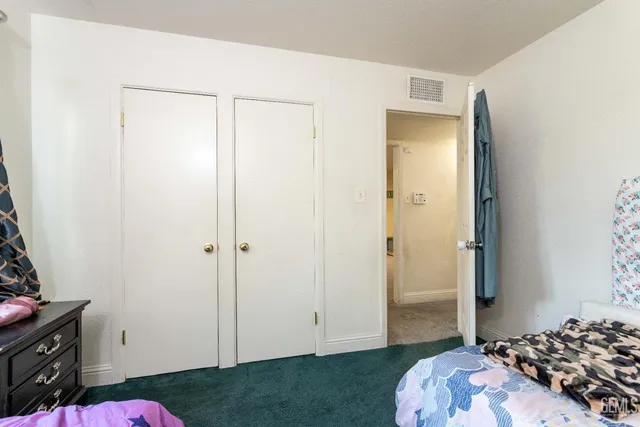 a bedroom with a bed and a dresser