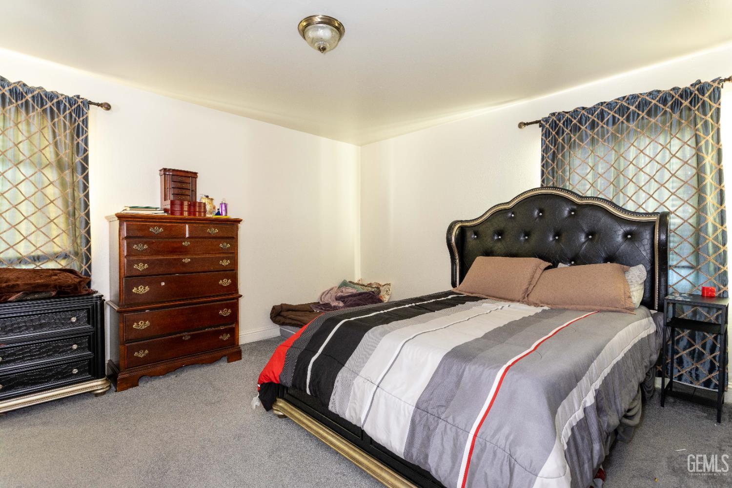 Undisclosed Address Delano, CA 93215 - Photo 22 of 35 a bedroom with a bed and a closet