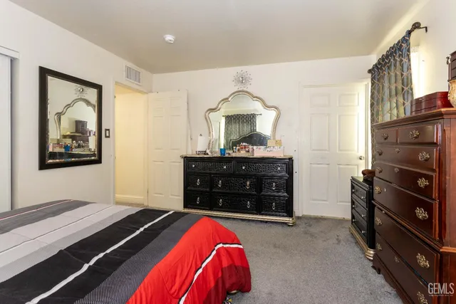 a bedroom with a bed and a dresser