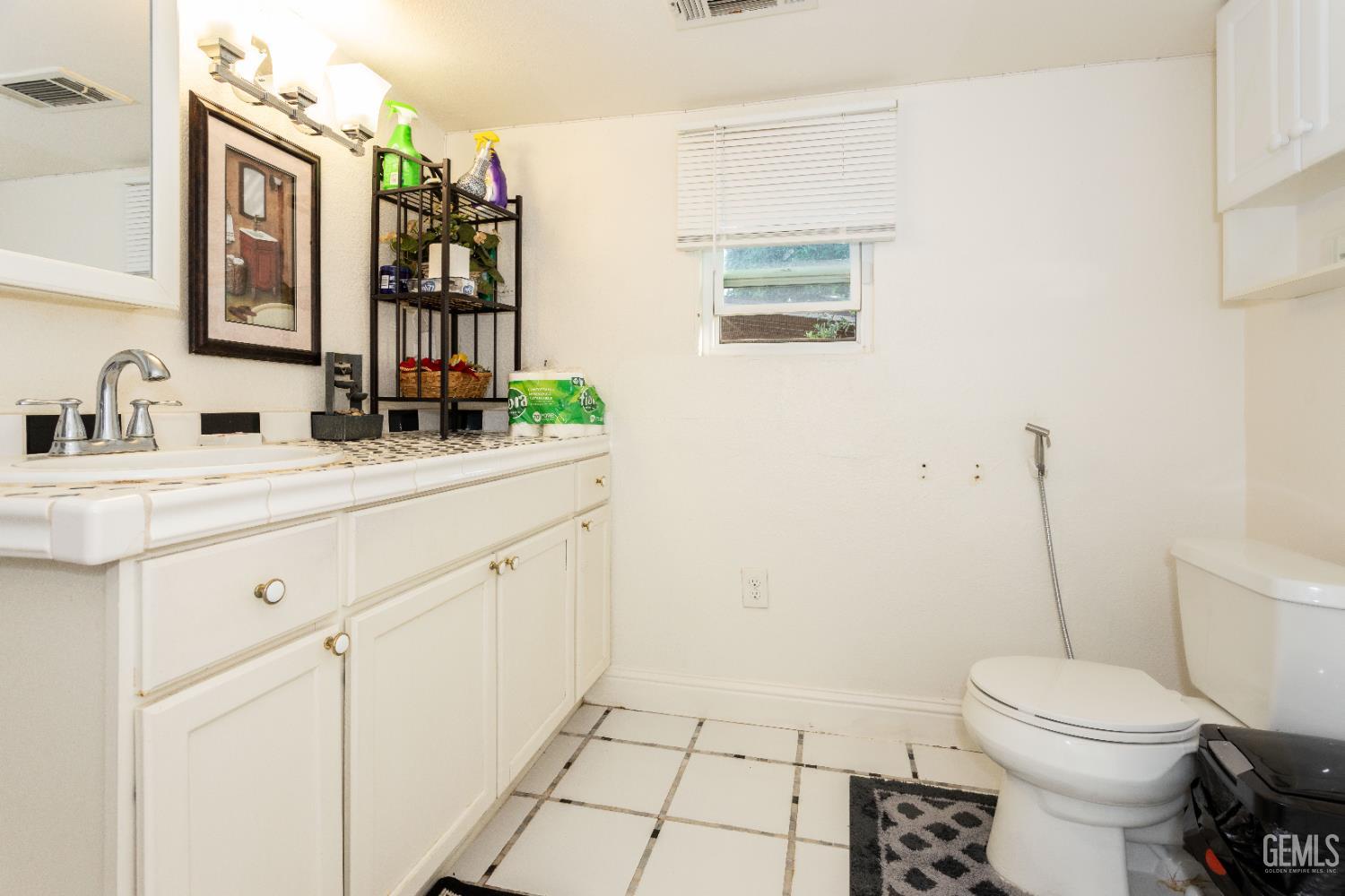 Undisclosed Address Delano, CA 93215 - Photo 25 of 35 a bathroom with a toilet sink and mirror