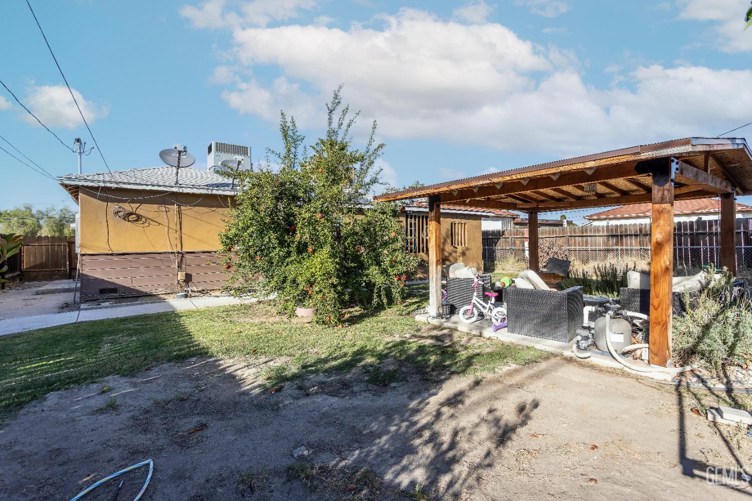 Undisclosed Address Delano, CA 93215 - Photo 30 of 35 a backyard of a house with yard and outdoor seating