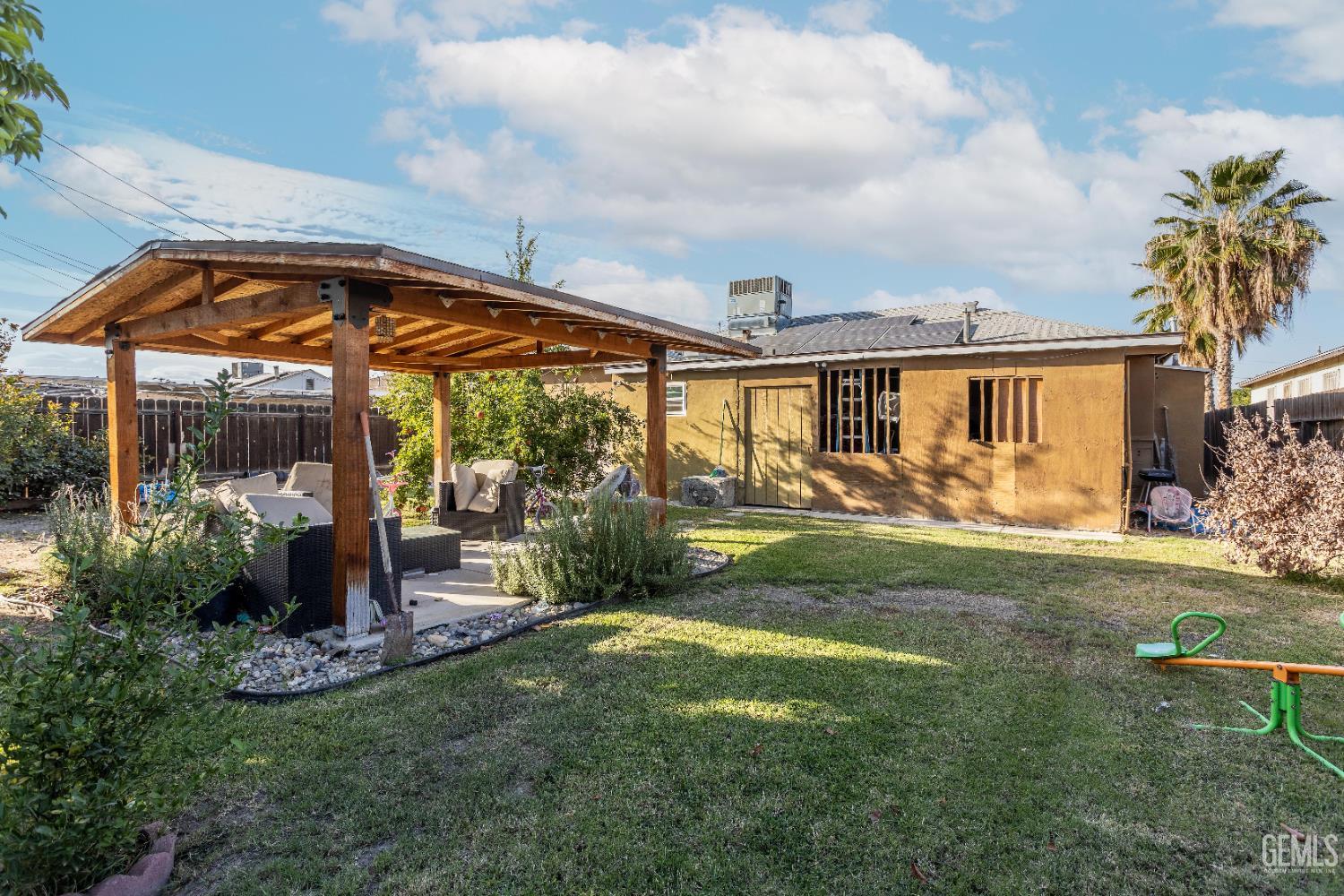 Undisclosed Address Delano, CA 93215 - Photo 31 of 35 a view of a house with backyard sitting area and garden