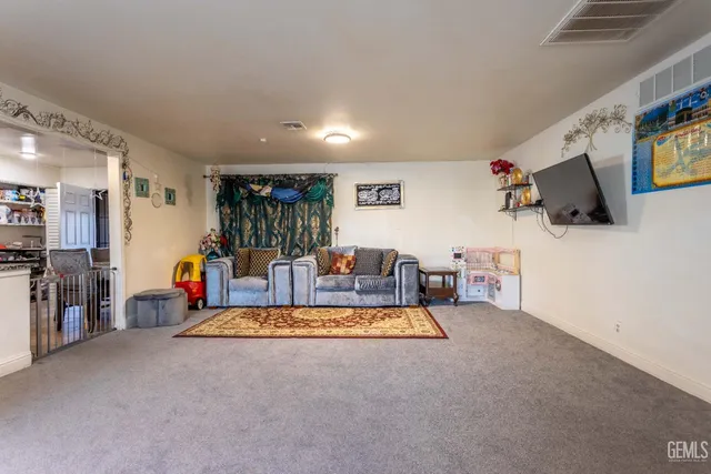 a living room with furniture gym equipment and a flat screen tv