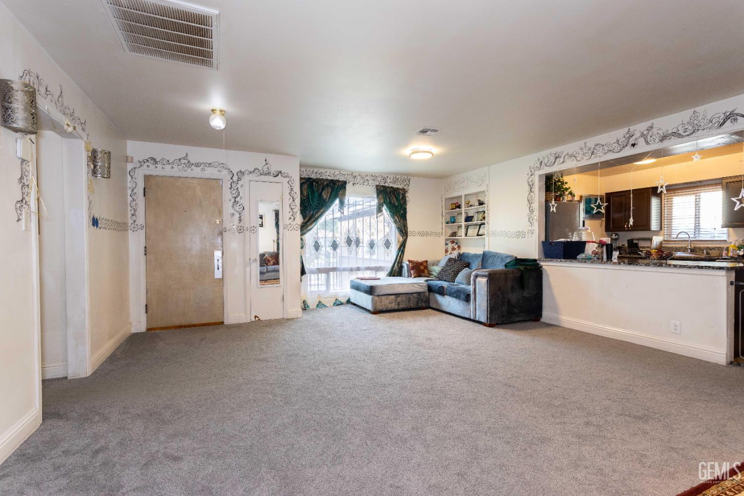 Undisclosed Address Delano, CA 93215 - Photo 9 of 35 a living room with furniture a couch and kitchen view