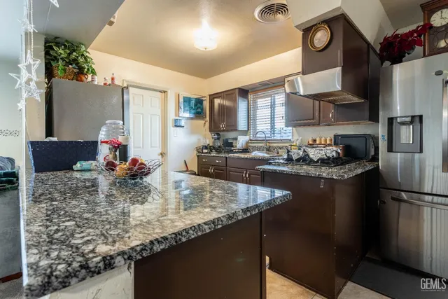 a kitchen with refrigerator and stove