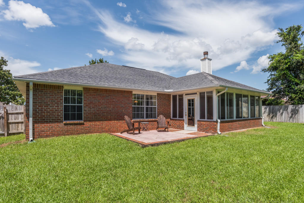 1969 Jessica Way Navarre, FL 32566 - Photo 14 of 17 a patio with a table and chairs and potted plants