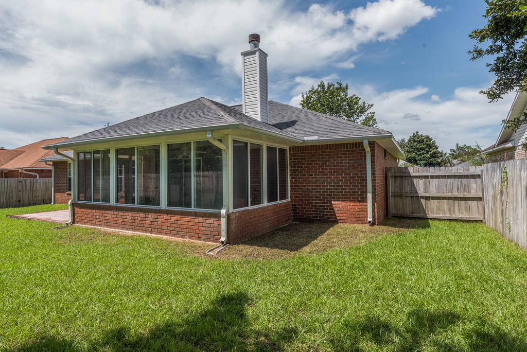 1969 Jessica Way Navarre, FL 32566 - Photo 15 of 17 a view of a house with a yard and a garden